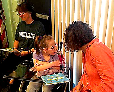 Reading a story to a child at Make it Take it